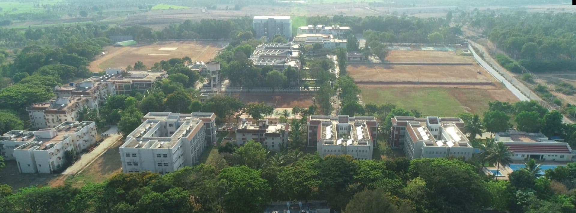 Aerial view of the Bapuji SPSS PU College campus, showing hostel blocks, playing fields and the swimming pool
